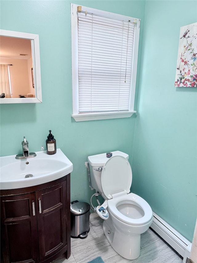 467 Scranton Ave, Lynbrook, NY 11563 - bathroom featuring a baseboard radiator, vanity, and wood finished floors