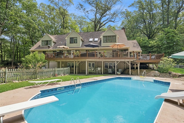 23 Bacon Rd, Head Of The Harbor, NY 11780 - view of pool featuring a diving board, a water slide, a wooden deck, and a patio area