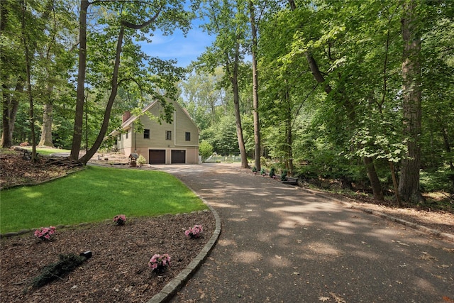 23 Bacon Rd, Head Of The Harbor, NY 11780 - view of home's exterior featuring driveway, an attached garage, and a lawn