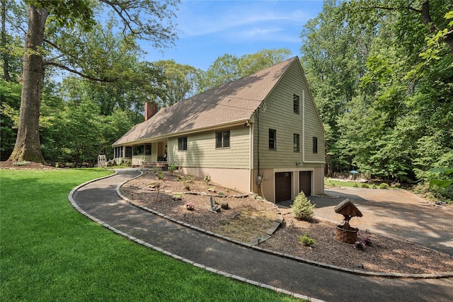 23 Bacon Rd, Head Of The Harbor, NY 11780 - view of front of property with an attached garage, a front lawn, a chimney, and concrete driveway