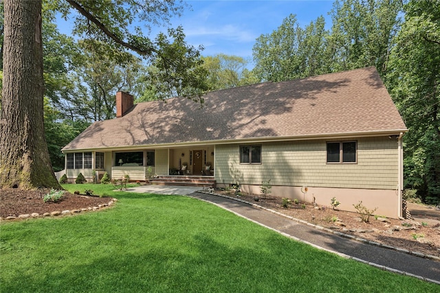 23 Bacon Rd, Head Of The Harbor, NY 11780 - view of front of property featuring a chimney, a front yard, a shingled roof, and covered porch