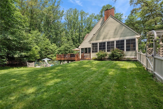 23 Bacon Rd, Head Of The Harbor, NY 11780 - back of property with a sunroom, a chimney, a fenced backyard, and a deck