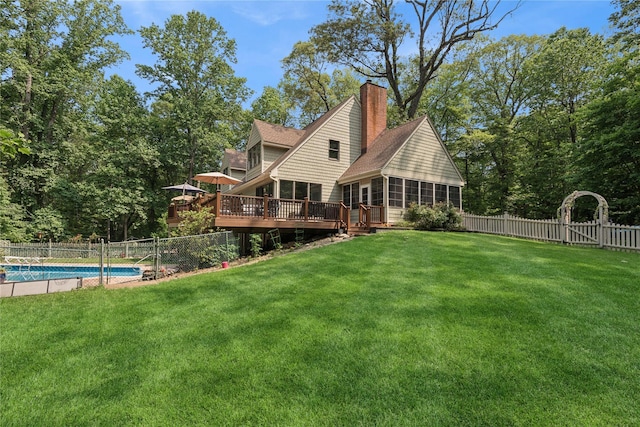 23 Bacon Rd, Head Of The Harbor, NY 11780 - back of property featuring a sunroom, a fenced backyard, a deck, a chimney, and roof with shingles