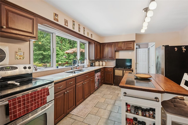23 Bacon Rd, Head Of The Harbor, NY 11780 - kitchen featuring appliances with stainless steel finishes, butcher block counters, decorative backsplash, and light stone finish floors