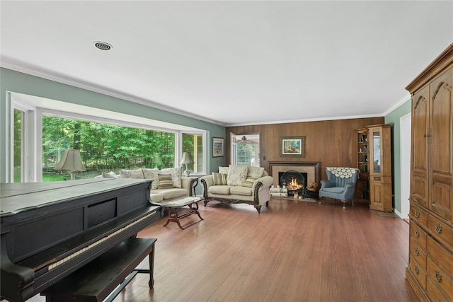 23 Bacon Rd, Head Of The Harbor, NY 11780 - living room with crown molding, wood finished floors, and a lit fireplace