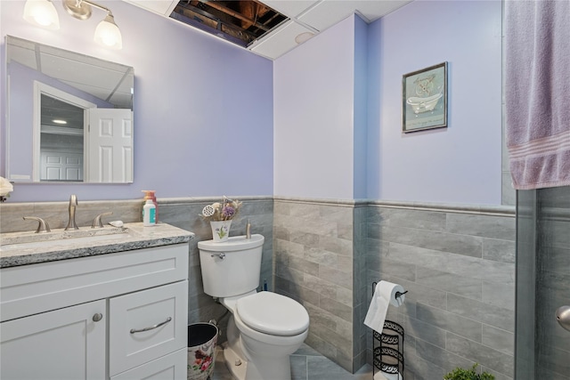 23 Bacon Rd, Head Of The Harbor, NY 11780 - bathroom featuring vanity, wainscoting, and tile walls
