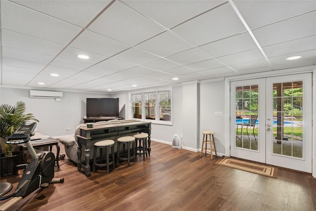 23 Bacon Rd, Head Of The Harbor, NY 11780 - bar area with a wall mounted AC, wood finished floors, french doors, recessed lighting, and a drop ceiling