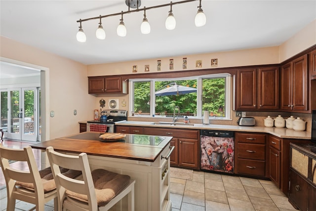 23 Bacon Rd, Head Of The Harbor, NY 11780 - kitchen with dishwasher, stainless steel electric stove, light countertops, a kitchen island, and a kitchen breakfast bar