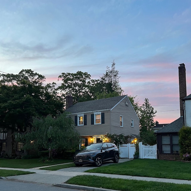 227 Elm St, West Hempstead, NY 11552 - view of front of house featuring driveway and a chimney
