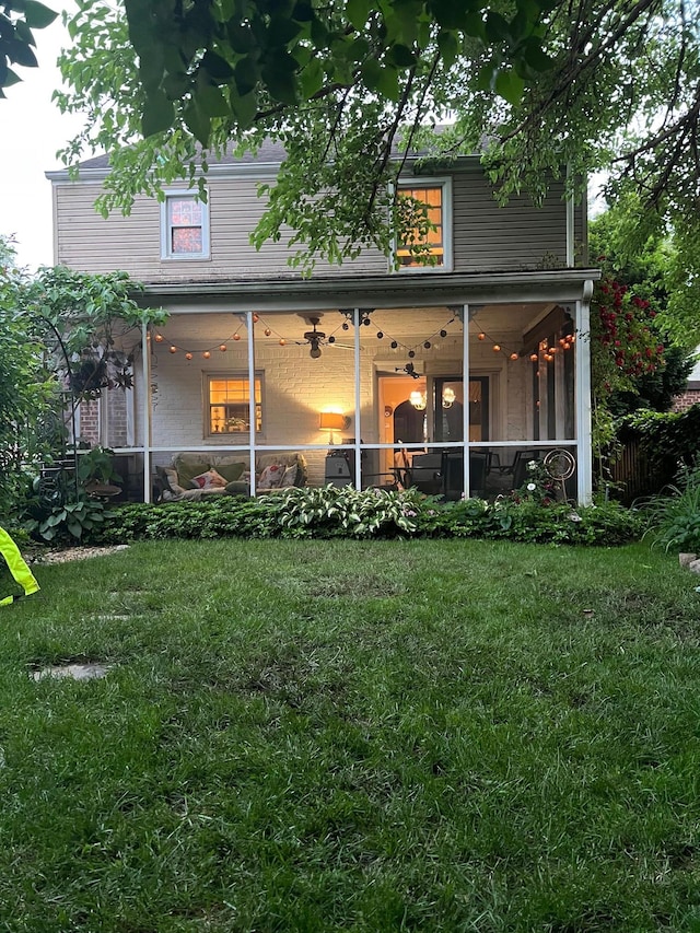 227 Elm St, West Hempstead, NY 11552 - back of house featuring a yard and a sunroom