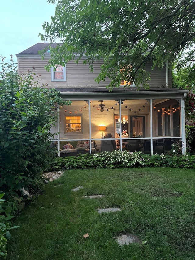 227 Elm St, West Hempstead, NY 11552 - rear view of house with a lawn, a ceiling fan, and a sunroom