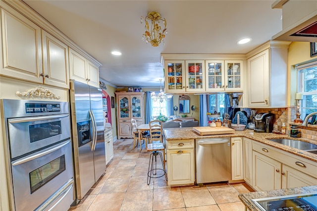 227 Elm St, West Hempstead, NY 11552 - kitchen featuring stainless steel appliances, cream cabinets, and recessed lighting