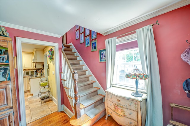 227 Elm St, West Hempstead, NY 11552 - staircase with crown molding and wood finished floors
