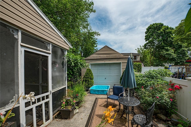 227 Elm St, West Hempstead, NY 11552 - view of patio / terrace featuring an outbuilding and a garage