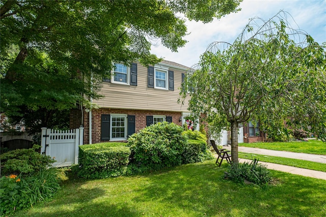 227 Elm St, West Hempstead, NY 11552 - colonial house featuring brick siding and concrete driveway