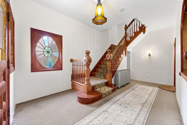 610 Van Cortlandt Park Ave, Yonkers, NY 10705 - entrance foyer with carpet floors, radiator heating unit, and stairway