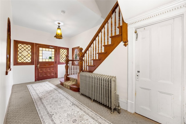 610 Van Cortlandt Park Ave, Yonkers, NY 10705 - carpeted foyer with radiator and stairs