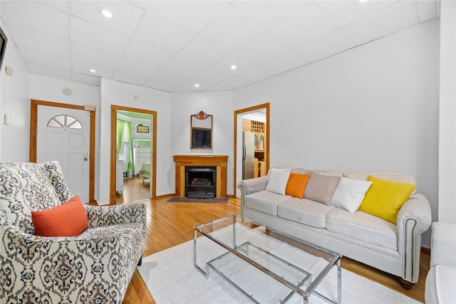 610 Van Cortlandt Park Ave, Yonkers, NY 10705 - living area with wood finished floors, a fireplace with flush hearth, a paneled ceiling, and recessed lighting