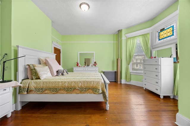 610 Van Cortlandt Park Ave, Yonkers, NY 10705 - bedroom featuring wood-type flooring and a textured ceiling