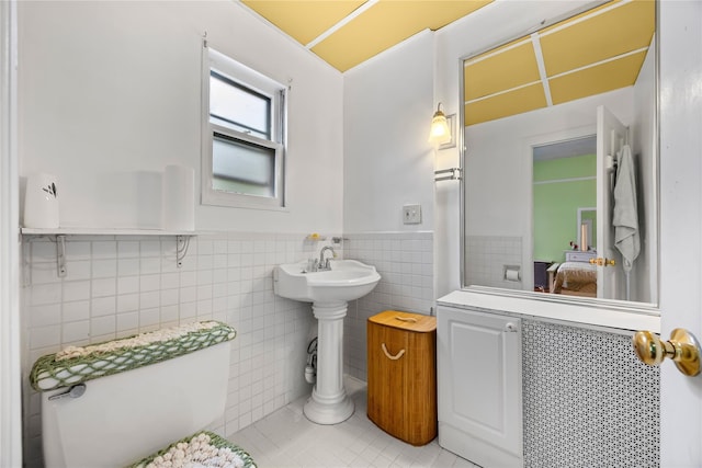 610 Van Cortlandt Park Ave, Yonkers, NY 10705 - ensuite bathroom with tile patterned flooring, wainscoting, and tile walls