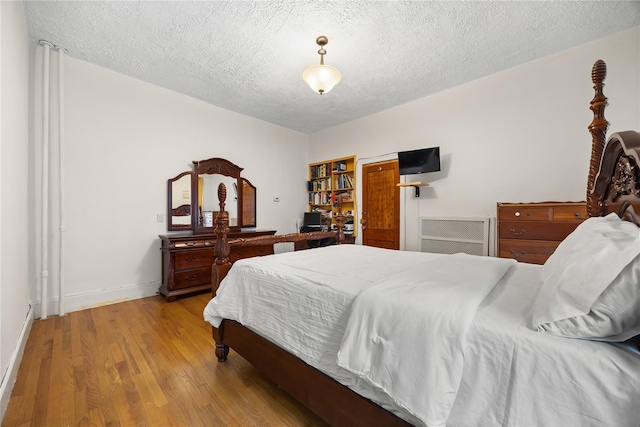 610 Van Cortlandt Park Ave, Yonkers, NY 10705 - bedroom with a textured ceiling and light wood finished floors