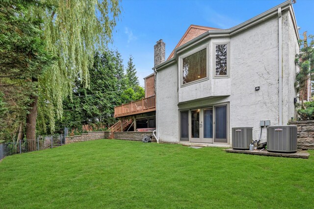 26 Vanderbilt Rd, Manhasset, NY 11030 - rear view of house featuring stucco siding, stairway, a deck, and a chimney