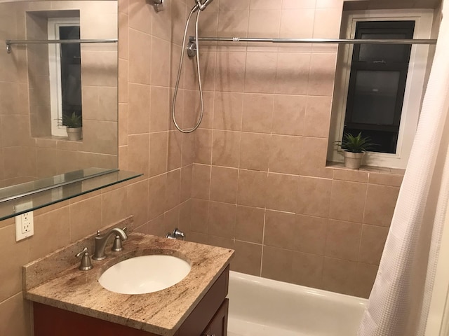 102-25 67th Rd Unit 5D, Forest Hills, NY 11375 - bathroom featuring vanity, shower / tub combo with curtain, tasteful backsplash, and tile walls