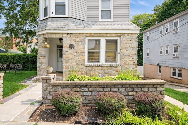 93 Edgewood Ave, Yonkers, NY 10704 - view of front of home with stone siding, a shingled roof, and cooling unit