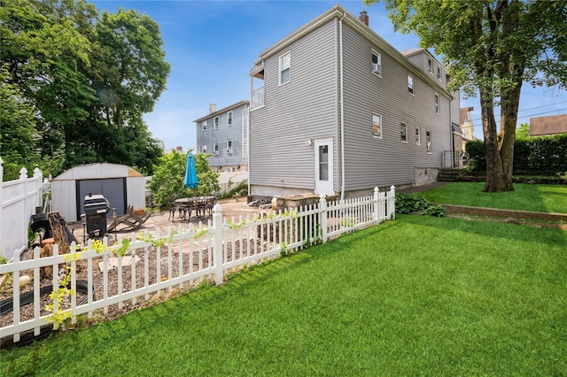 93 Edgewood Ave, Yonkers, NY 10704 - rear view of property featuring a storage shed, a fenced backyard, and a patio