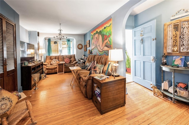 93 Edgewood Ave, Yonkers, NY 10704 - living room with arched walkways, light wood-style floors, and a chandelier