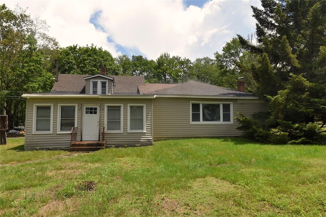 3216 State Route 42, Monticello, NY 12701 - view of front facade with a chimney, a front lawn, entry steps, and a shingled roof