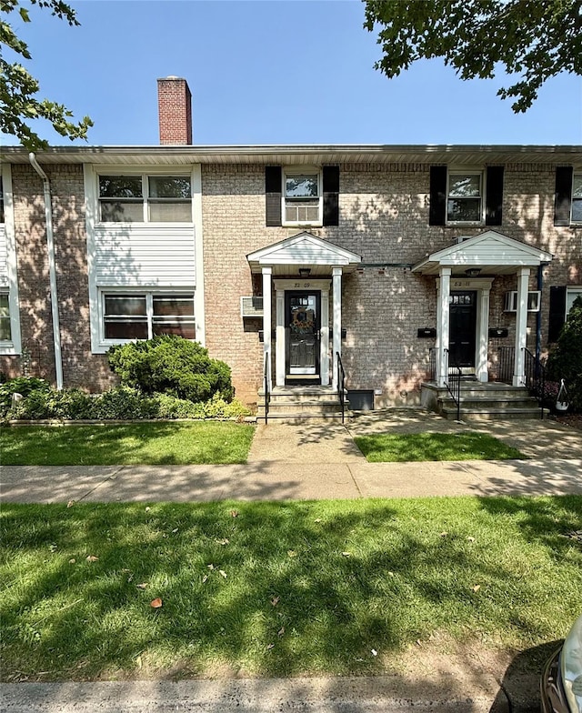 82-09 268th St Apt B, New Hyde Park, NY 11040 - multi unit property featuring a chimney, brick siding, and a front yard