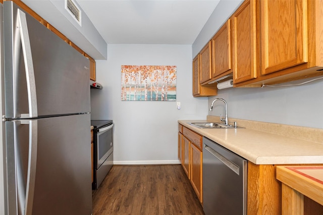26Cooper Road 307, Poughkeepsie, NY 12603 - kitchen with appliances with stainless steel finishes, light countertops, dark wood-type flooring, and brown cabinets