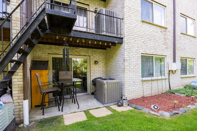 26Cooper Road 307, Poughkeepsie, NY 12603 - back of house with a balcony, brick siding, a patio, and stairway