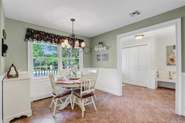 1 Willis Ave, Port Jefferson, NY 11777 - dining space with a chandelier, a wainscoted wall, and light tile patterned flooring