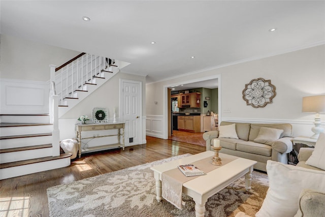 1 Willis Ave, Port Jefferson, NY 11777 - living area with wood finished floors, stairs, ornamental molding, wainscoting, and a decorative wall