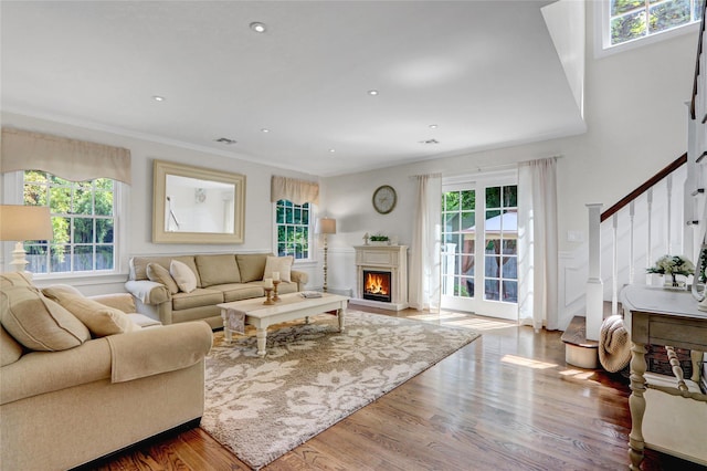 1 Willis Ave, Port Jefferson, NY 11777 - living room featuring stairs, wood finished floors, ornamental molding, a lit fireplace, and recessed lighting