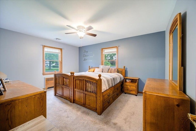 64 Mountainview Rd, Fishkill, NY 12524 - bedroom with radiator heating unit, multiple windows, light colored carpet, and a ceiling fan