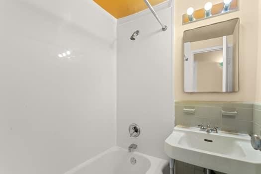 4 Fordham Hill Oval Unit 12B, Bronx, NY 10468 - bathroom with tub / shower combination and a sink