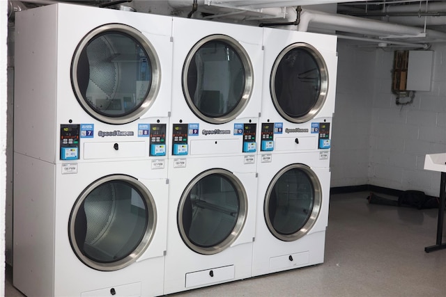 4 Fordham Hill Oval Unit 12B, Bronx, NY 10468 - community laundry room with stacked washing machine and dryer, washing machine and clothes dryer, concrete block wall, and electric panel