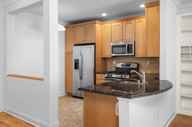 55 1st St Unit 207, Pelham, NY 10803 - kitchen with appliances with stainless steel finishes, dark stone countertops, decorative backsplash, a peninsula, and recessed lighting