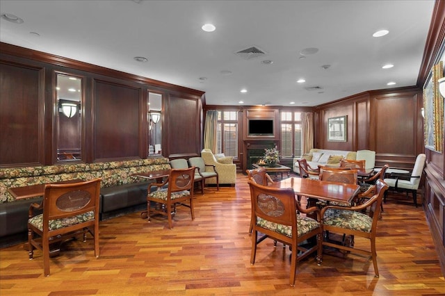55 1st St Unit 207, Pelham, NY 10803 - dining room featuring a lit fireplace, ornamental molding, light wood-style floors, and recessed lighting