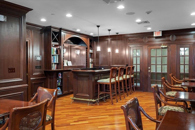55 1st St Unit 207, Pelham, NY 10803 - indoor dry bar featuring light wood finished floors, pendant lighting, recessed lighting, and crown molding