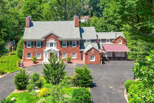 400 Beechmont Dr, New Rochelle, NY 10804 - colonial home featuring a chimney, brick siding, and driveway