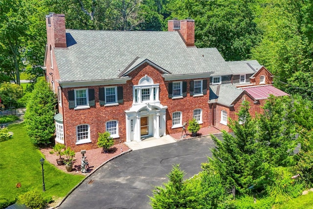 400 Beechmont Dr, New Rochelle, NY 10804 - georgian-style home featuring a chimney, brick siding, driveway, and a front lawn