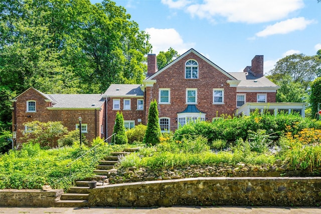 400 Beechmont Dr, New Rochelle, NY 10804 - georgian-style home featuring a chimney, stairs, and brick siding