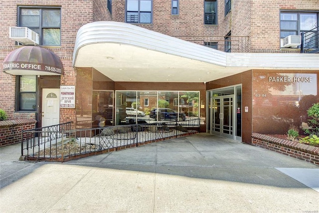 63-84 Saunders St Unit 2G, Rego Park, NY 11374 - entrance to property with brick siding and cooling unit