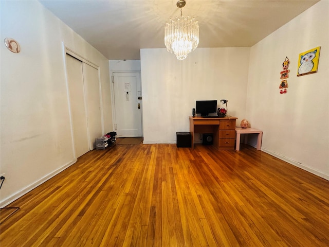 63-84 Saunders St Unit 2G, Rego Park, NY 11374 - unfurnished living room featuring a chandelier and wood finished floors