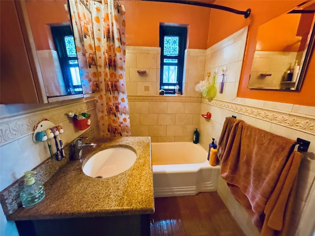 63-84 Saunders St Unit 2G, Rego Park, NY 11374 - full bathroom with a tub to relax in, tile walls, wood finished floors, vanity, and a shower with curtain