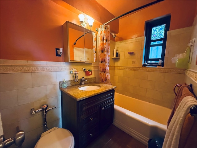 63-84 Saunders St Unit 2G, Rego Park, NY 11374 - full bathroom featuring vanity, tile walls, shower / tub combo, and wainscoting
